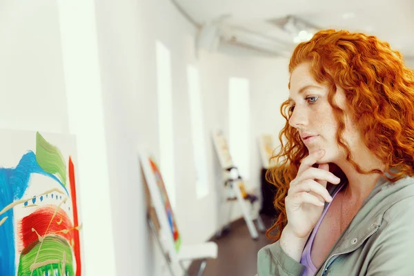 Jonge Kaukasische vrouw in kunst galerij voor schilderijen — Stockfoto