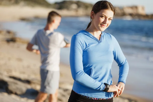 Jeune couple sur la plage d'entraînement ensemble — Photo