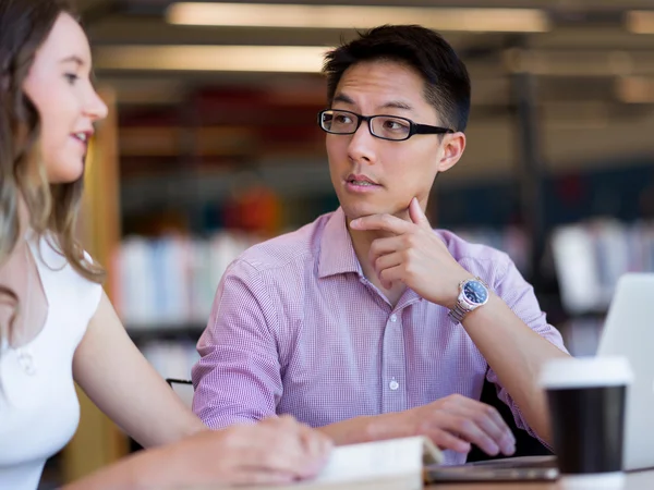Happy male student working at the library — Stock Photo, Image