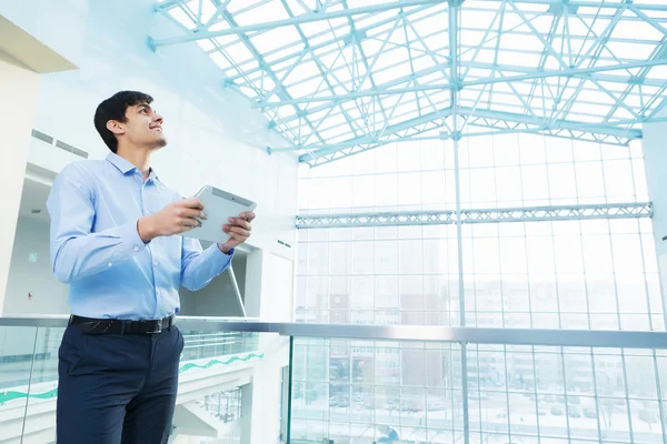 Businessman leaning on balcony railings — Stock Photo, Image