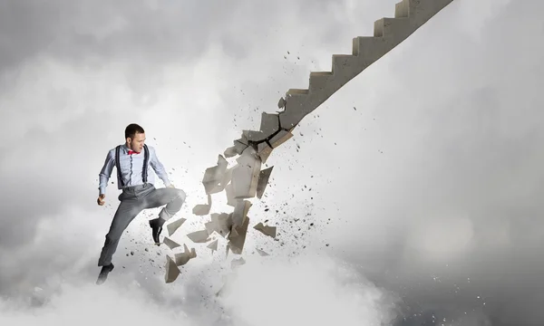 Man breaking ladder — Stock Photo, Image