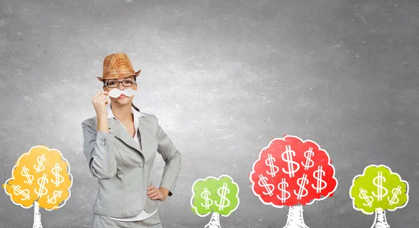 Businesswoman trying paper mustache — Stock Photo, Image