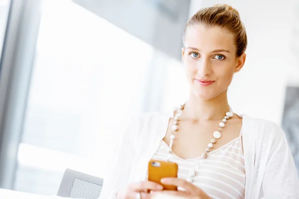 Attractive office worker sitting at desk — Stock Photo, Image