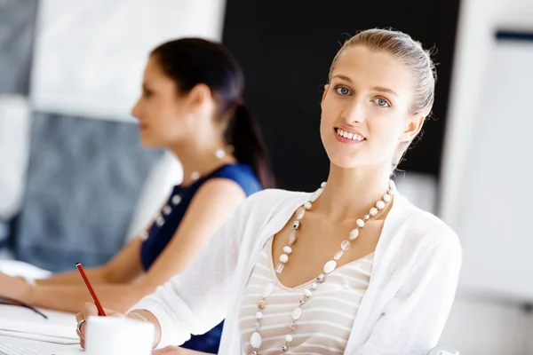 Attractive office worker sitting at desk — Stock Photo, Image