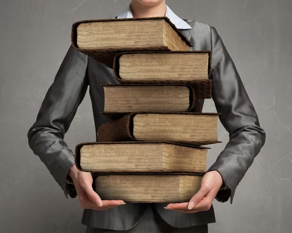 Woman carrying stack of books — Stock Photo, Image