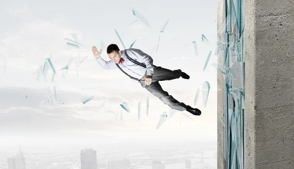 Man breaking through glass — Stock Photo, Image