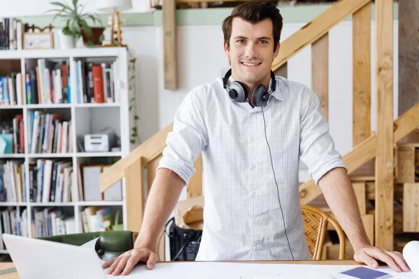 Young man standing in creative office — Stock Photo, Image