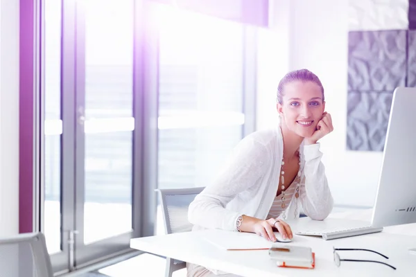 Attractive office worker sitting at desk — Stock Photo, Image