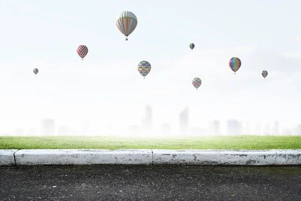 Aerostats flying over city — Stock Photo, Image