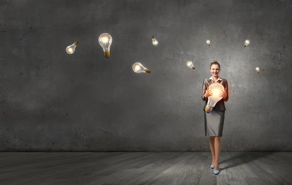 Woman with big bulb in hands — Stock Photo, Image