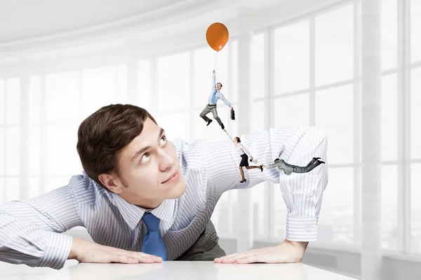 Gran hombre de negocios espiando desde debajo de la mesa — Foto de Stock