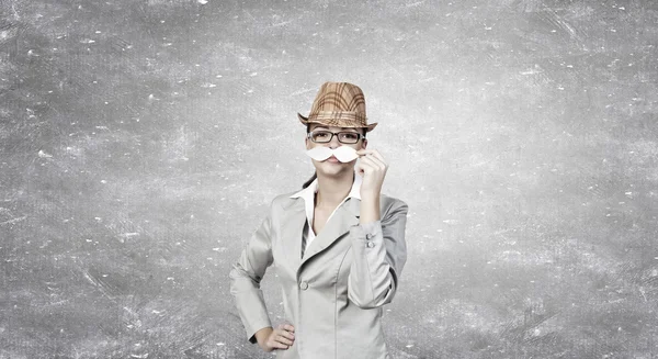 Businesswoman trying paper mustache — Stock Photo, Image