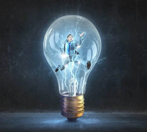 Man inside of electric bulb — Stock Photo, Image