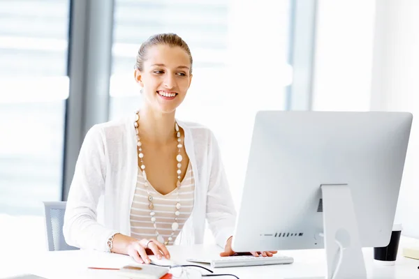 Attractive office worker sitting at desk — Stock Photo, Image