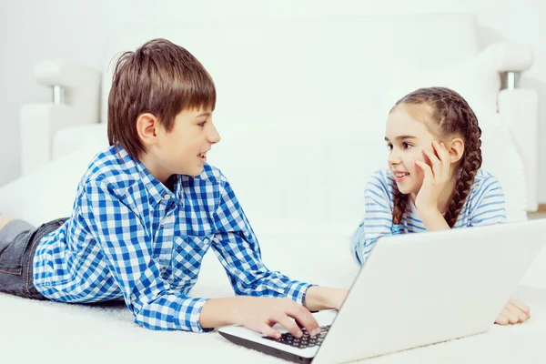 Cute kids using devices — Stock Photo, Image