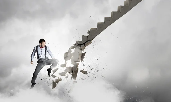 Man breaking ladder — Stock Photo, Image