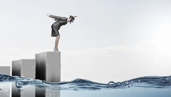 Businesswoman jumping in water — Stock Photo, Image
