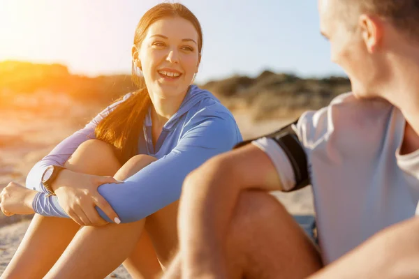 Pareja en ropa deportiva en la playa —  Fotos de Stock