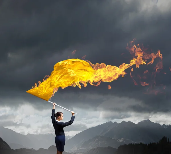 Woman waving yellow flag — Stock Photo, Image