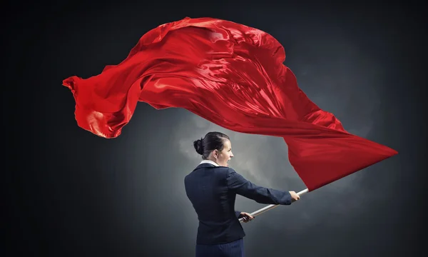 Mujer ondeando bandera roja — Foto de Stock
