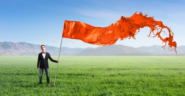 Homem com bandeira ondulada — Fotografia de Stock