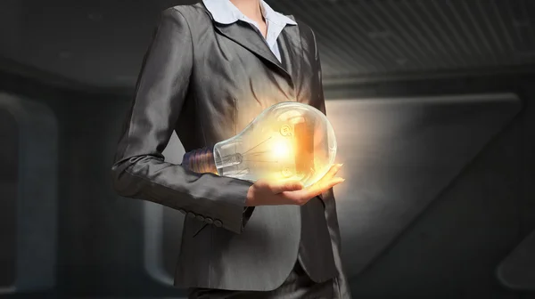 Electric bulb in woman hand — Stock Photo, Image