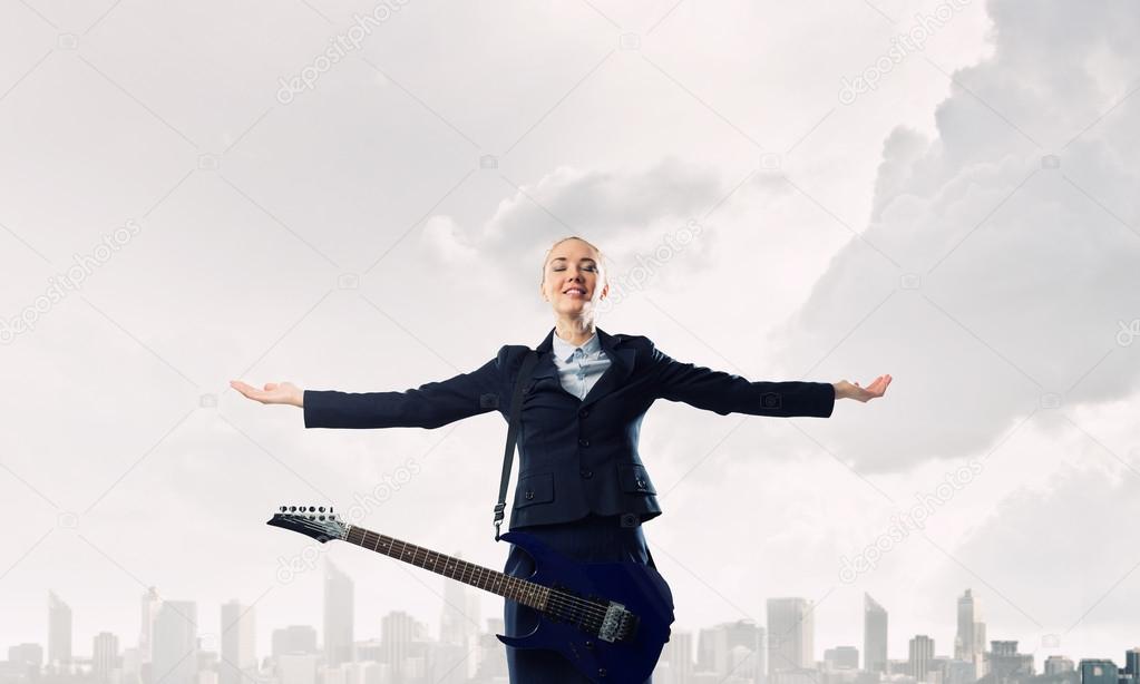 Successful businesswoman with guitar