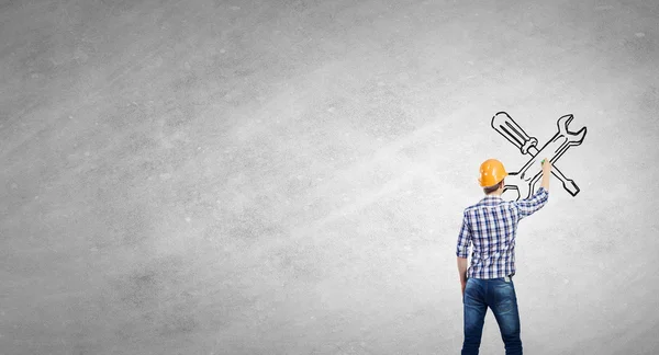 Builder man drawing on wall — Stock Photo, Image