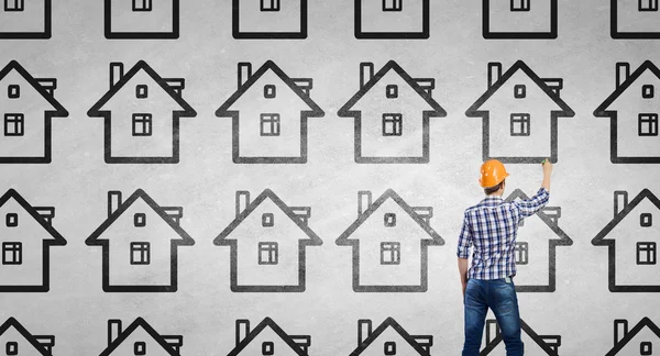 Builder man drawing on wall — Stock Photo, Image