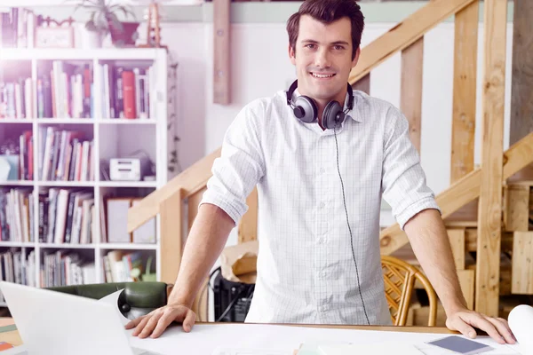 Young man standing in creative office — Stock Photo, Image