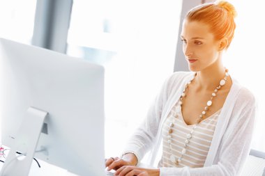 Çekici ofis çalışanı masada oturuyor.