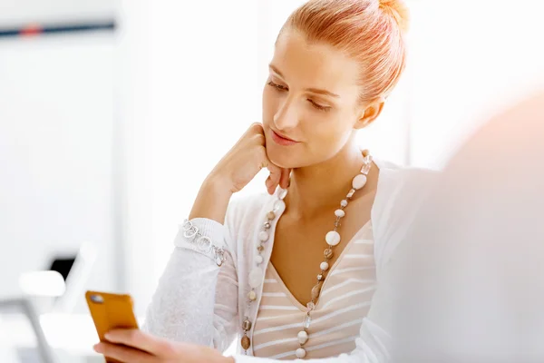 Attractive office worker sitting at desk — Stock Photo, Image