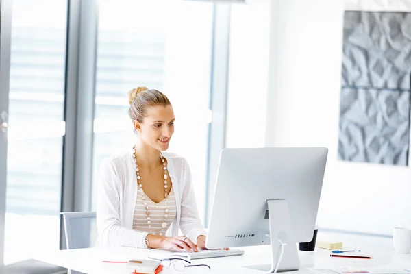 Attractive office worker sitting at desk — Stock Photo, Image