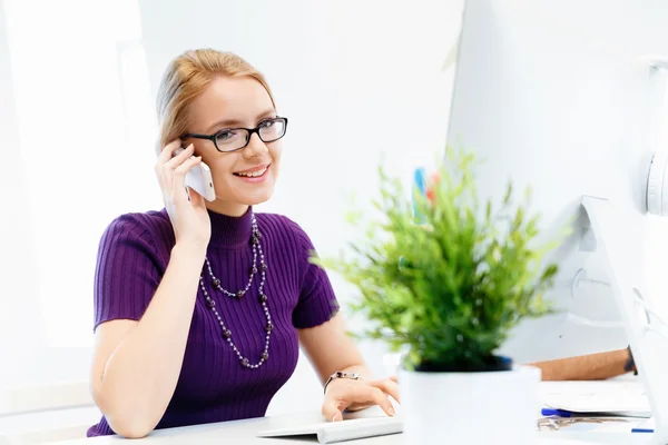 Femme d'affaires au bureau tenant un téléphone mobile — Photo