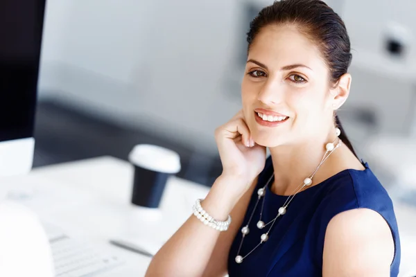 Attractive office worker sitting at desk — Stock Photo, Image