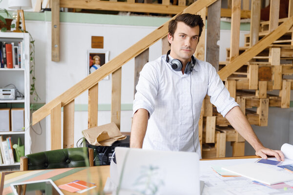 Young man standing in creative office