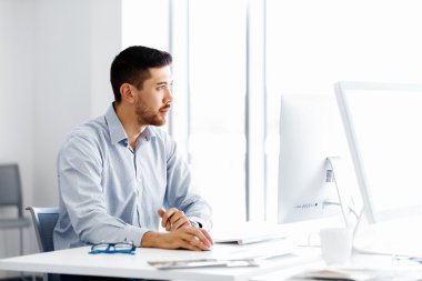 Masa başında oturan erkek ofis çalışanı