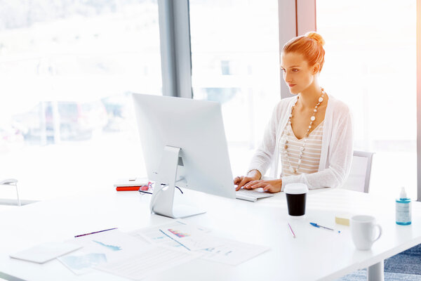 Attractive office worker sitting at desk