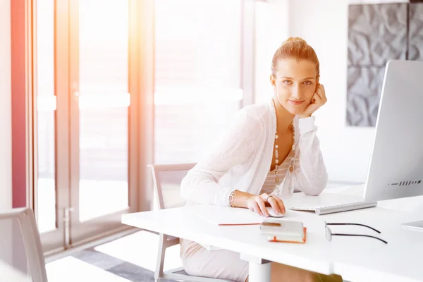 Attractive office worker sitting at desk — Stock Photo, Image