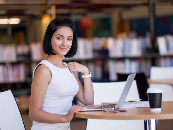 Happy female student at the library — Stock Photo, Image