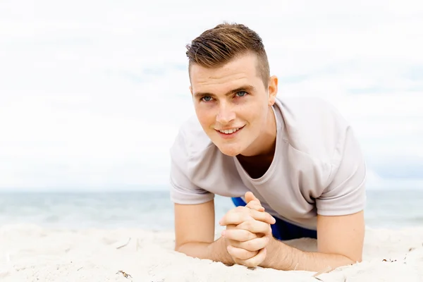 Man training on beach outside Royalty Free Stock Photos