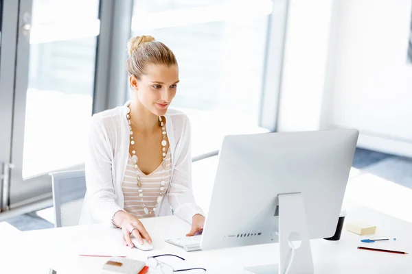 Attractive office worker sitting at desk — Stock Photo, Image