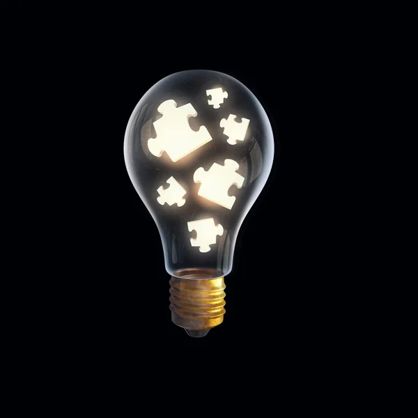 Jigsaw elements in bulb — Stock Photo, Image