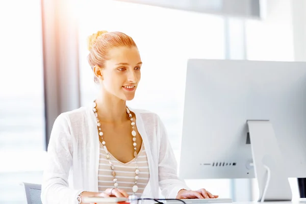 Attractive office worker sitting at desk — Stock Photo, Image