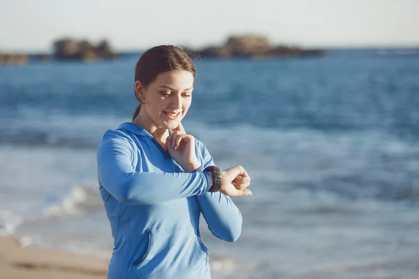 Běžec žena s srdeční frekvence monitoru běžící na pláži — Stock fotografie