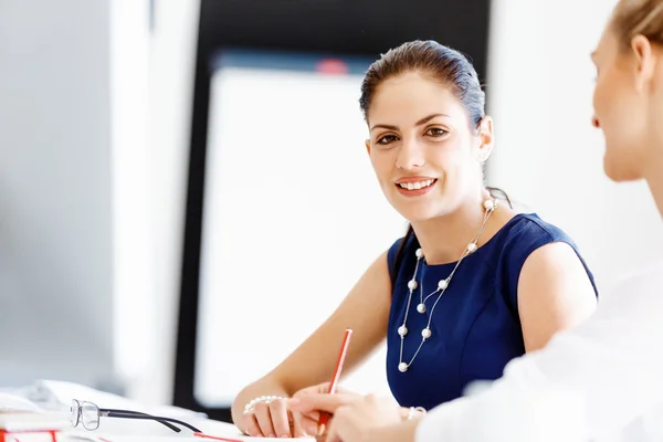 Attractive office worker sitting at desk — Stock Photo, Image