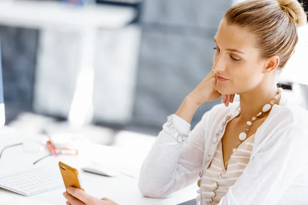 Attractive office worker sitting at desk — Stock Photo, Image