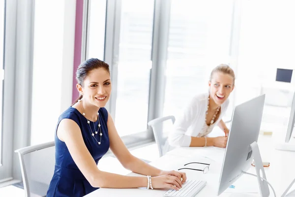 Attractive office worker sitting at desk — Stock Photo, Image