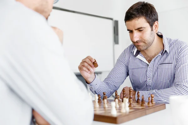 Portrait of two young man playing chess — Stock Photo, Image