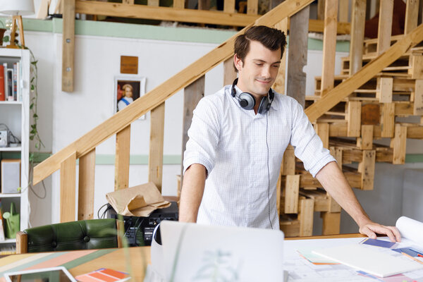 Young man standing in creative office